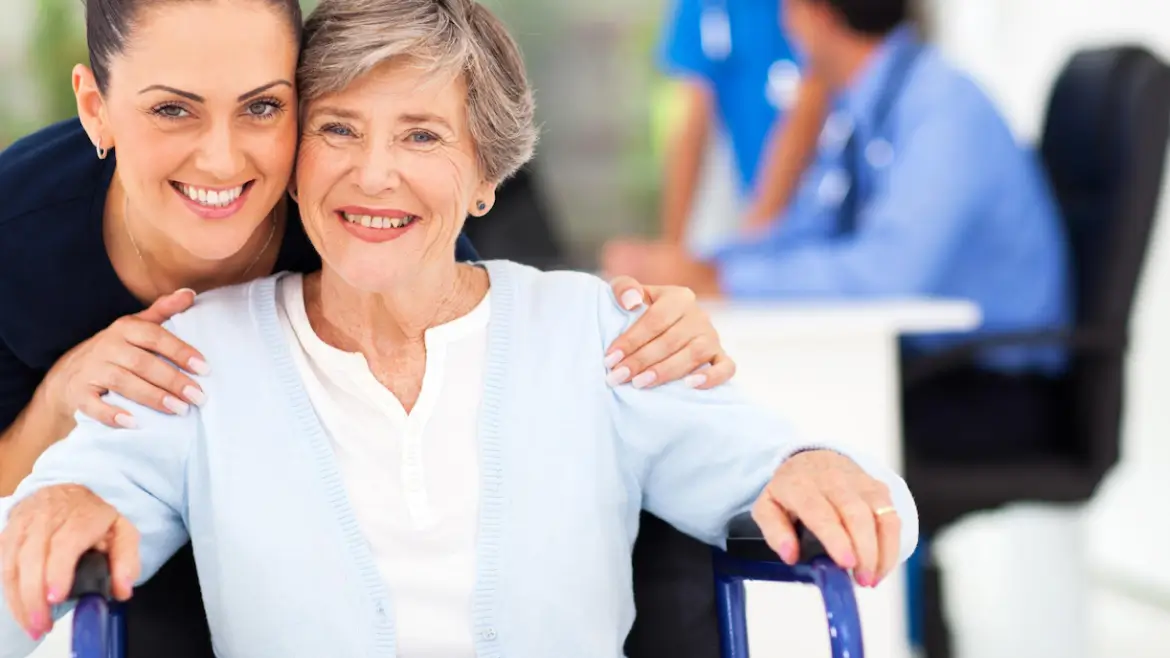 Compassionate caregiver supporting a smiling older adult receiving personalized home care services in Lansing, Michigan.