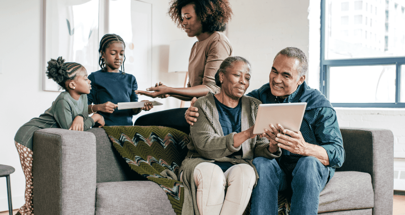 Older adults and family members using a tablet to access secure online home care payment services in Lansing, Michigan.