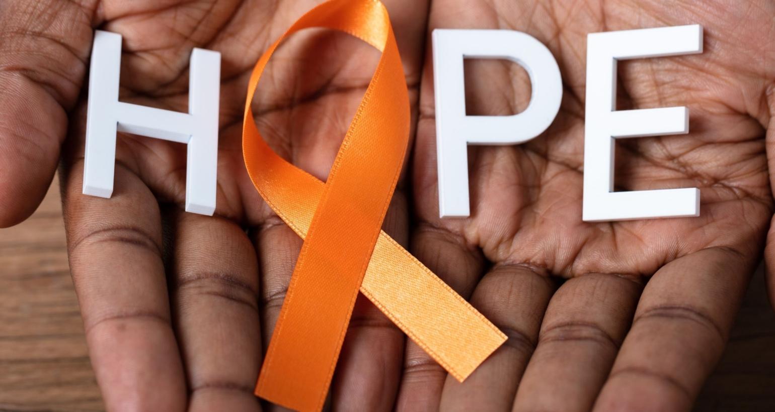 Orange multiple sclerosis awareness ribbon displayed with the word "HOPE" to promote Multiple Sclerosis Awareness Month and support for people living with MS.