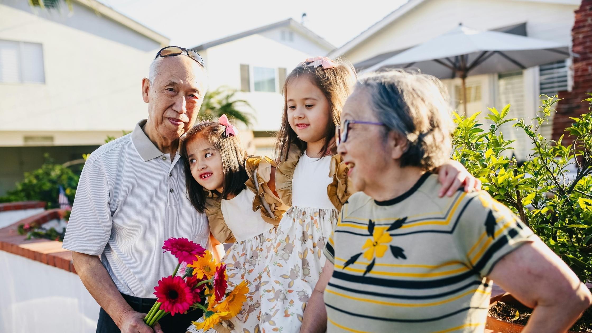 Senior couple enjoying time outdoors with family while practicing summer safety at home.